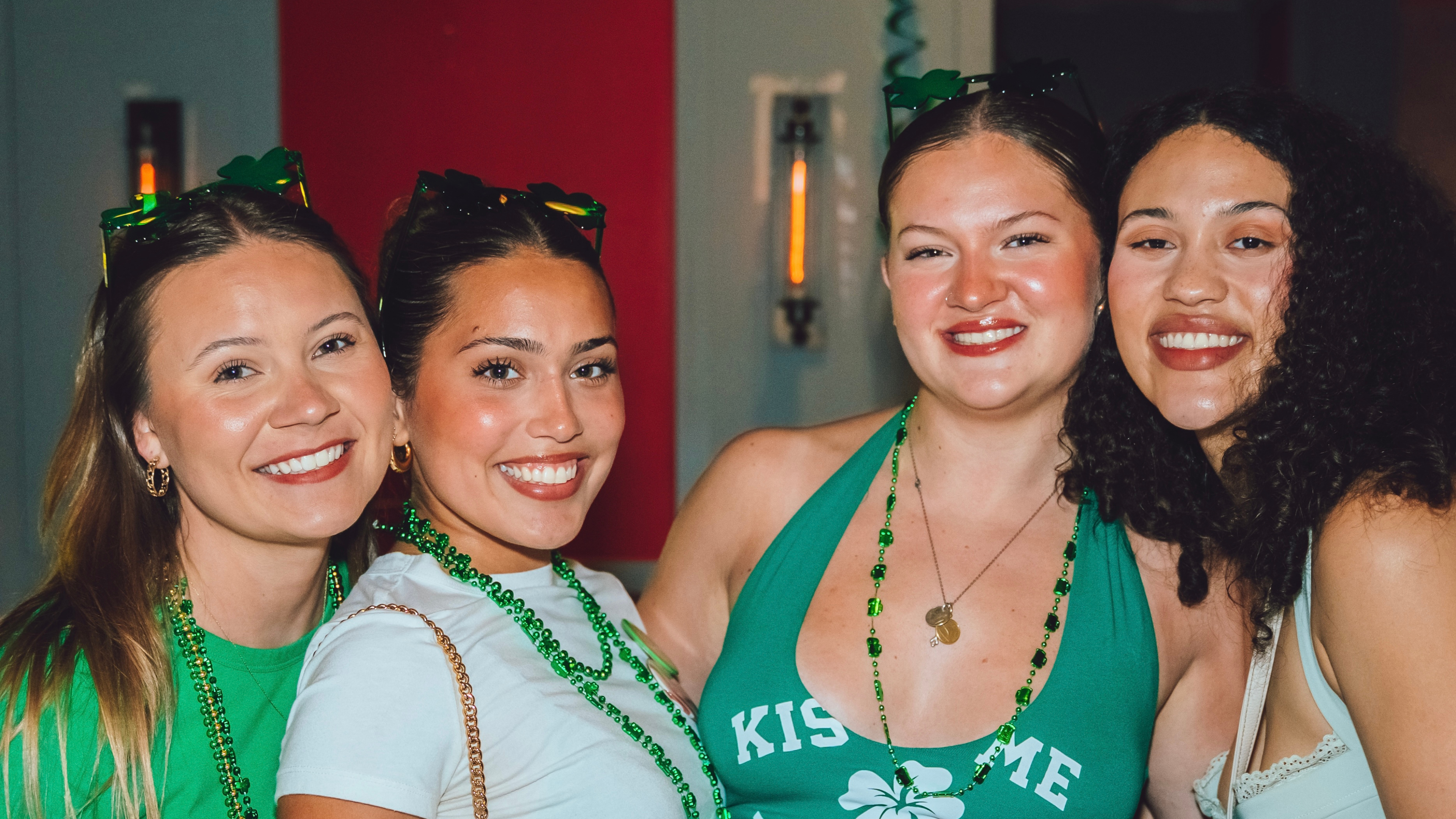 An image of 4 girls posing for a pic at shamrocks and Shenanigans.