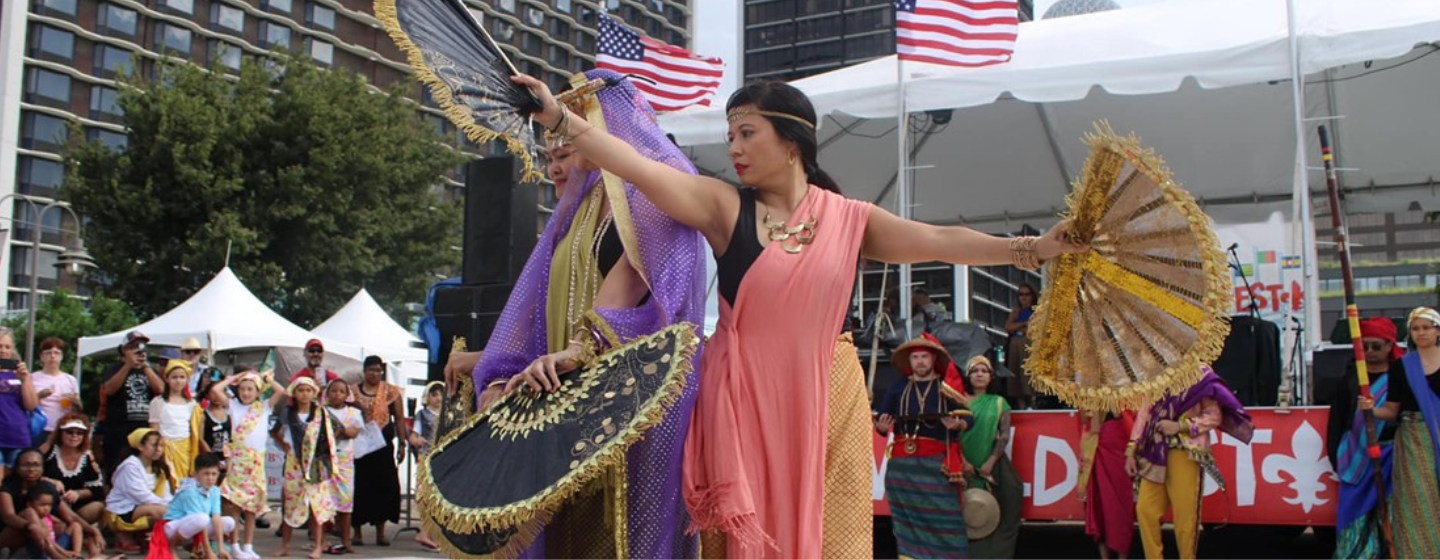 Cultura Philippines performing a dance with fans