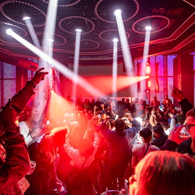 Spotlights streaming down on guests in Mosaic night club at the Power & Light District, Kansas City, MO. 