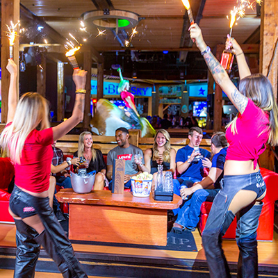 PBR Big Sky - Waitresses cheering with booth of people