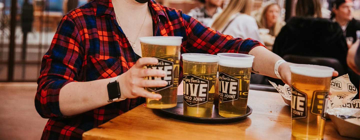 Server serving beers to guests