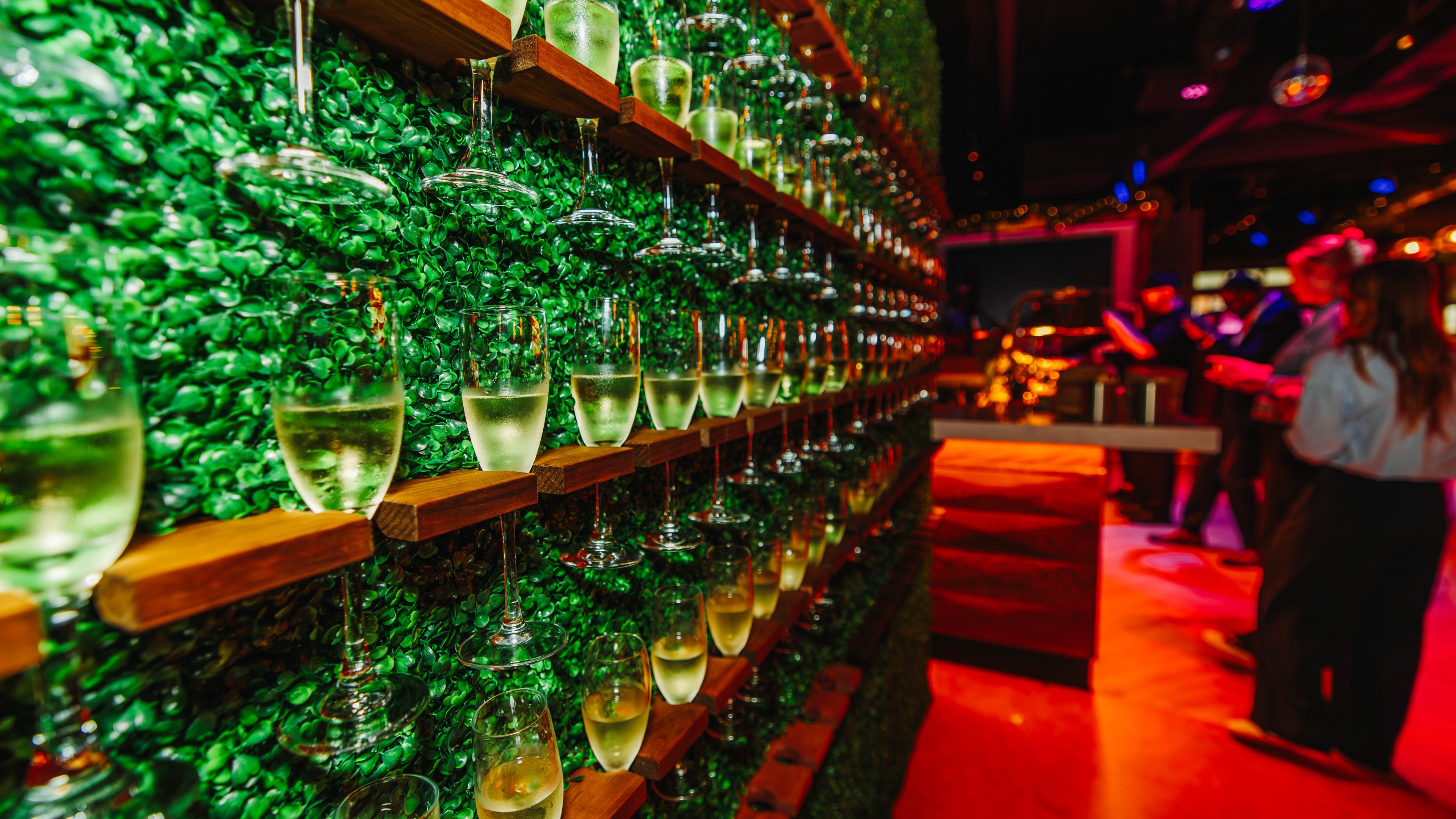 Champagne greenery wall at private event.