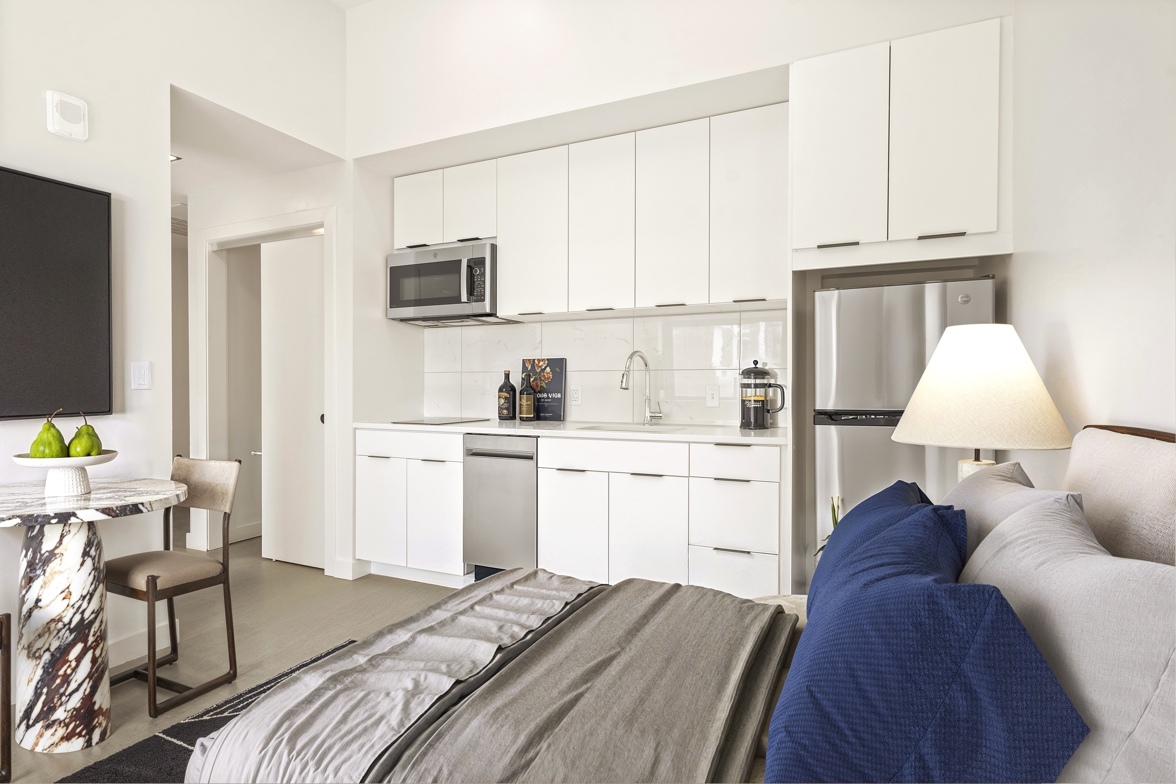 Midland Lofts studio with bed, kitchen, and living area.