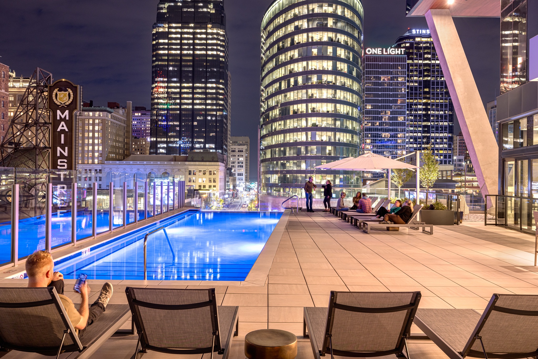 Outdoor pool and deck patio with nighttime skyline views at Three Light, Kansas City, MO.