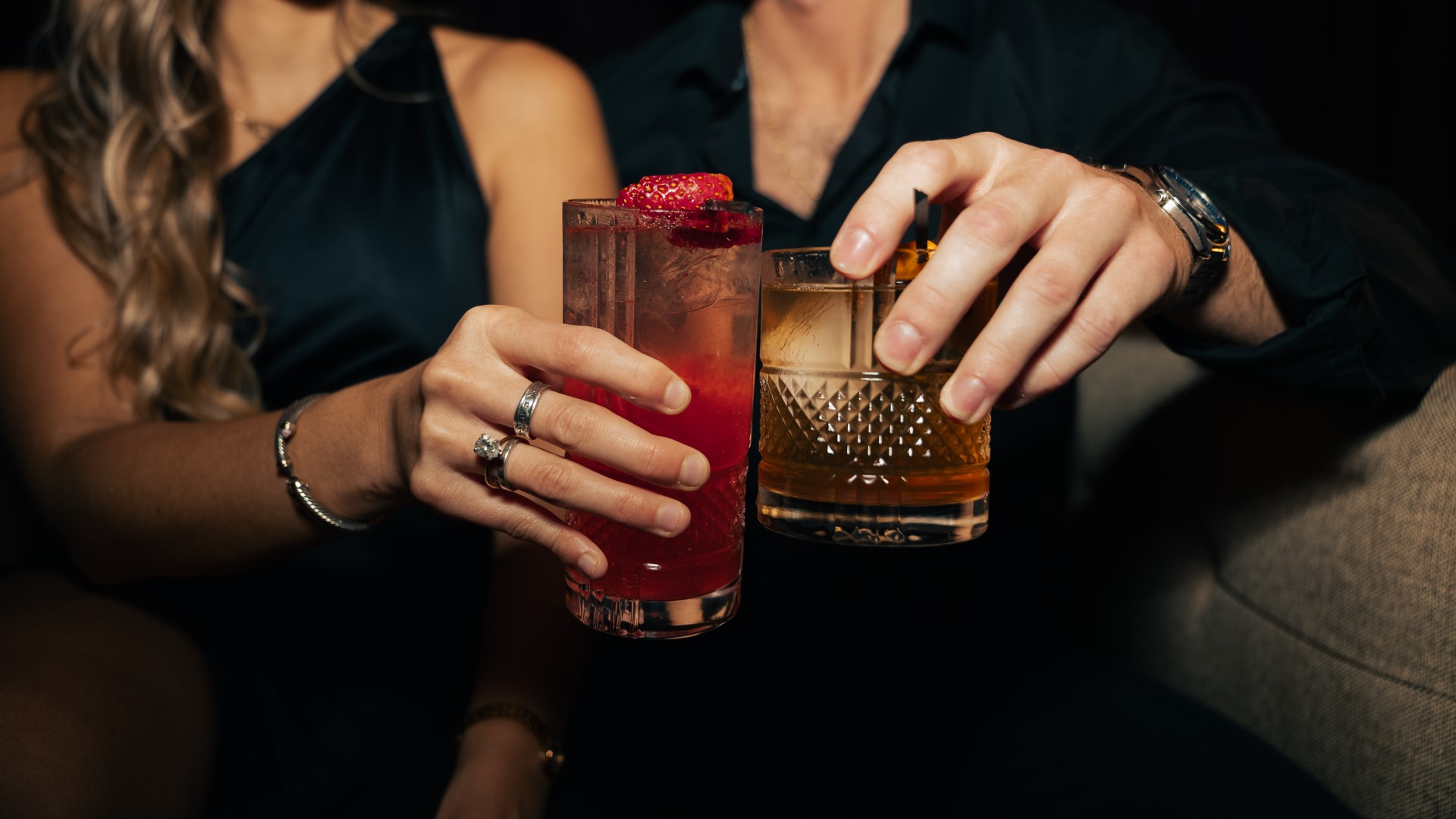 Women and man toasting cocktails at Houndsmen Lounge, Live! at the Pointe Orlando.