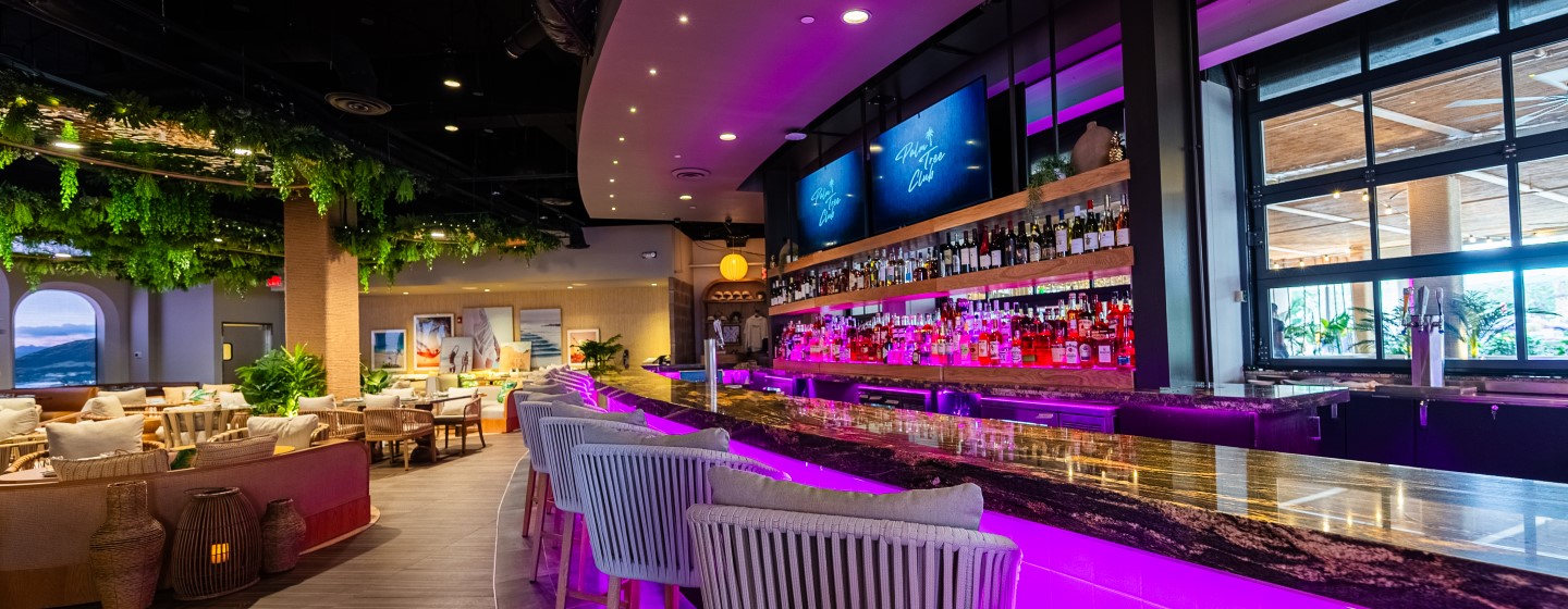 Bar and dining area at Palm Tree Club at Live! at the Pointe Orlando.