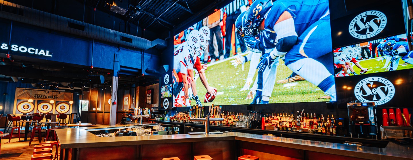 Main bar and big screen TVs at Sports & Social at Live! at the Pointe Orlando.