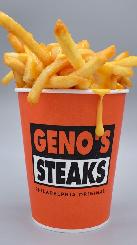 Geno's Steaks cup of fries dripping with cheese.