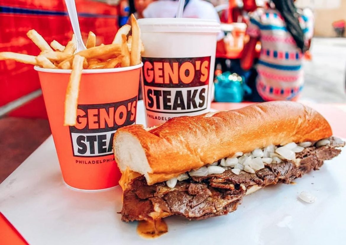 Geno's Steaks meal with drink, fries, and cheesesteak.