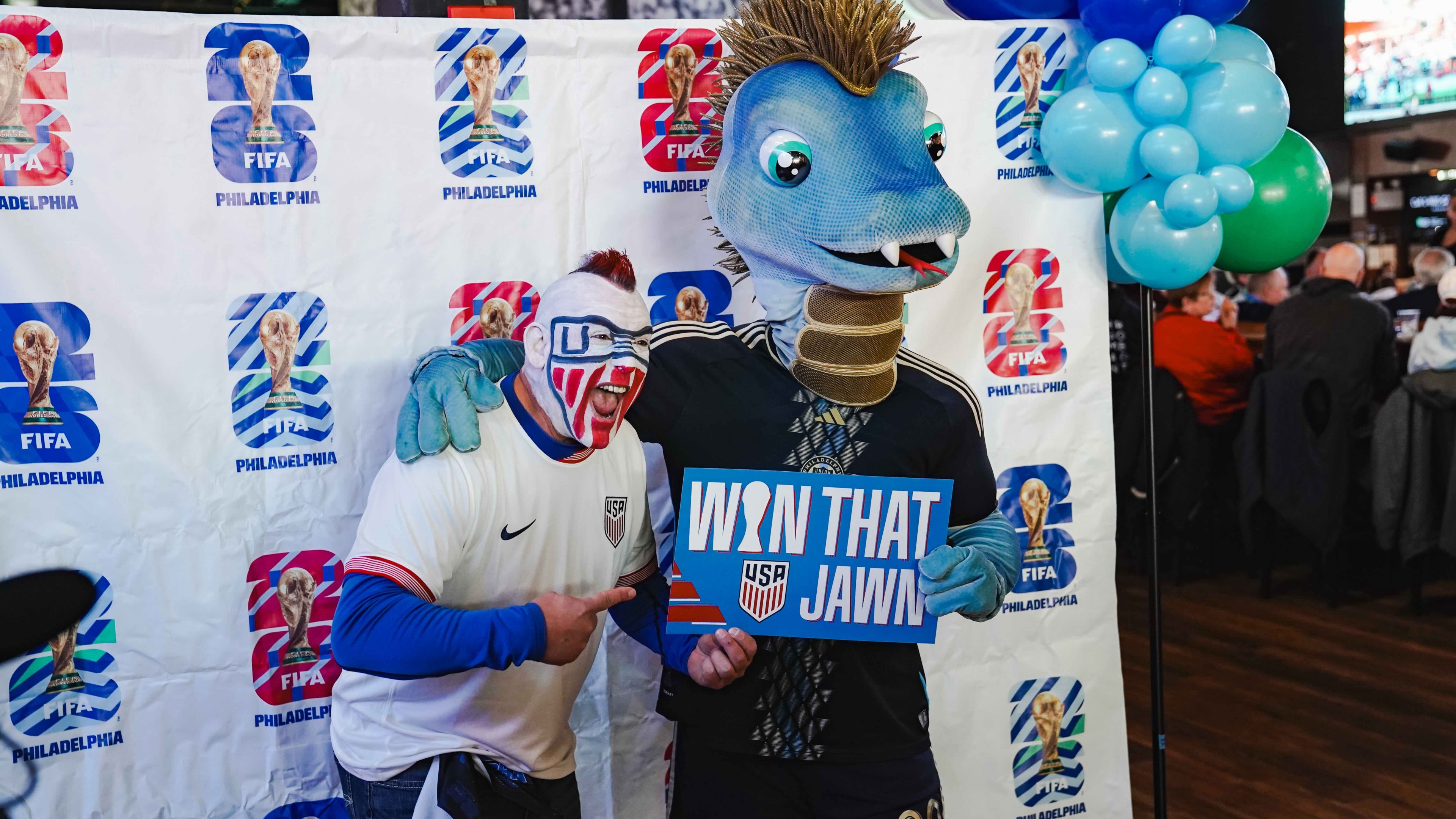 FIFA 2026 Philadelphia soccer fan with mascot at match day event.