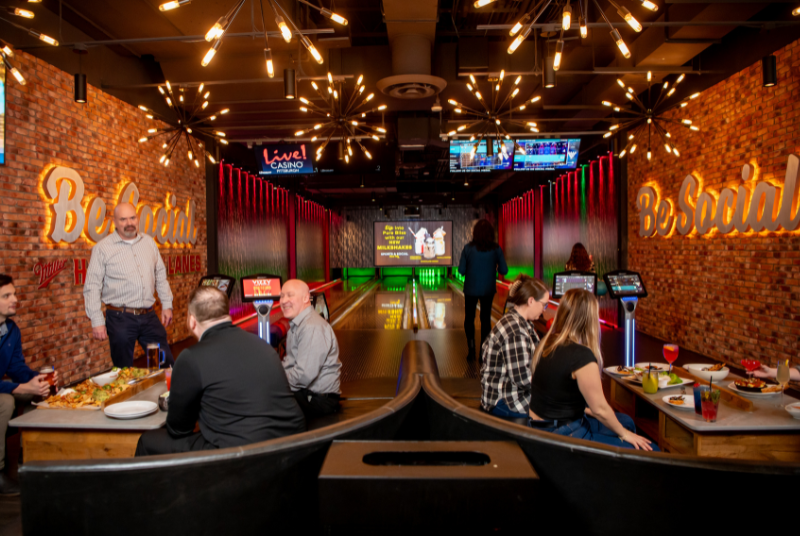 Group of people enjoying Sports & Social's Bowling Alley