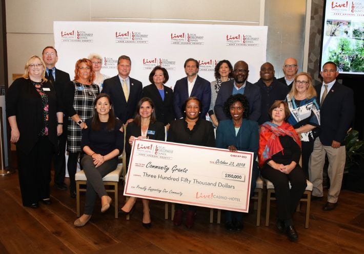 A photo of members of the Live! Local Development Council showing a giant check for $350,000