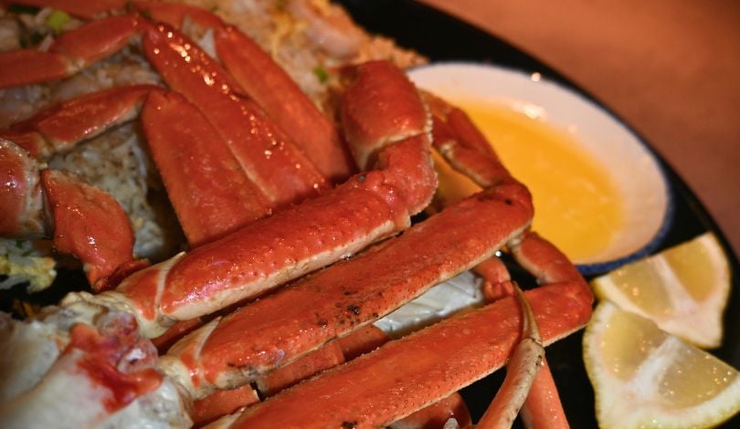 image of snow crab legs and shrimp fried rice with drawn butter and lemons at luk fu louisiana