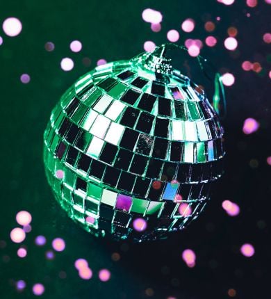 image of a green disco ball and purple confetti
