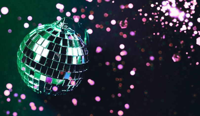 image of a green disco ball and purple confetti