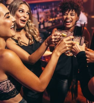 image of 5 people clinking their cocktail glasses together