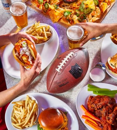 image of a football on a table full of food and beer at sports & social louisiana