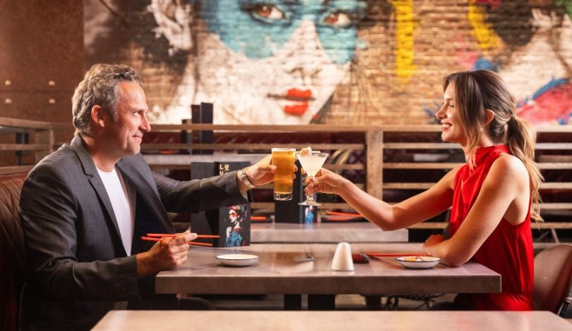 image of a couple toasting drinks together at luk fu louisiana
