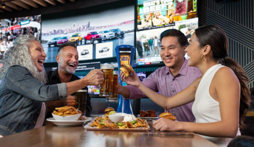 image of four people eating food at sports & social
