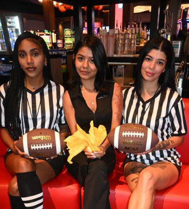 image of three girls at sports & social wearing referee shirts with footballs
