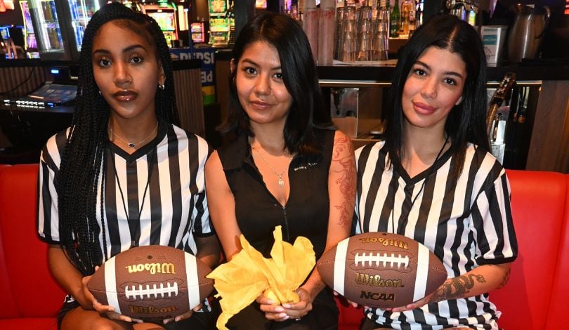 image of three girls at sports & social wearing referee shirts with footballs