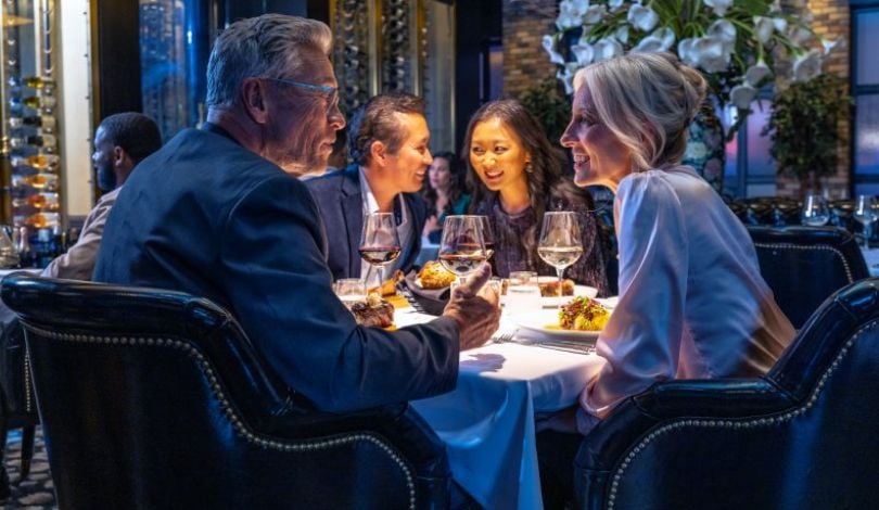 image of four people enjoying wine and dinner at the prime rib louisiana