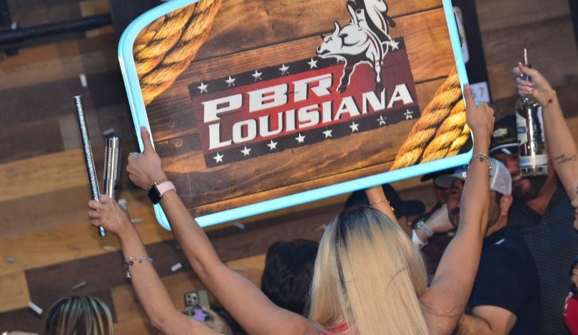image of people celebrating in a vip booth at pbr louisiana