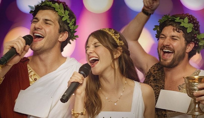 image of three people wearing togas doing karaoke