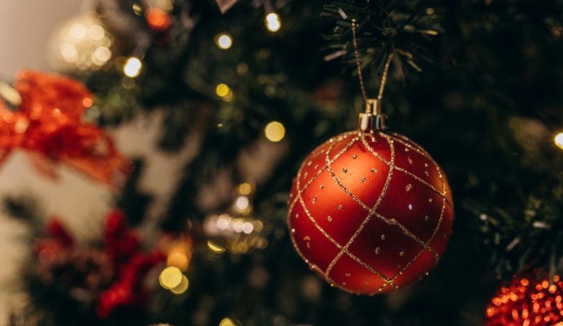image of red ornaments on a green christmas tree