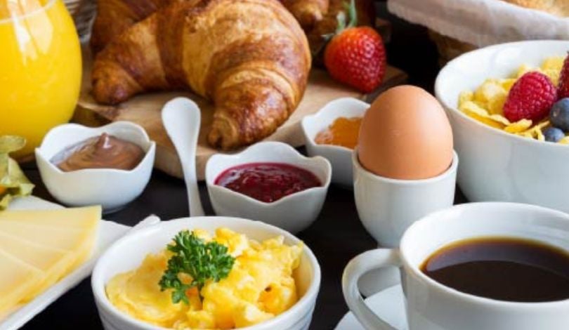 image of a spread of breakfast buffet items, croissants, eggs, coffee, cereal
