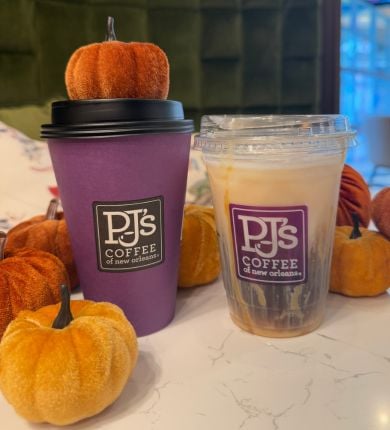 image of two coffee drinks with pumpkin decor on a counter