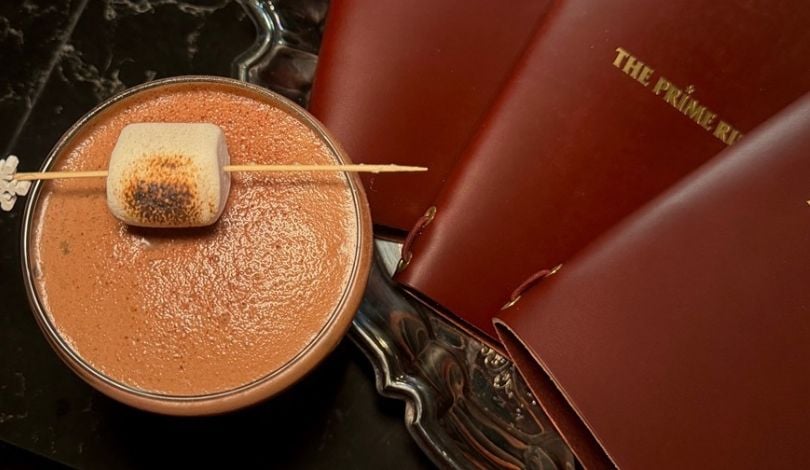 image of a cocktail and 3 red menu books