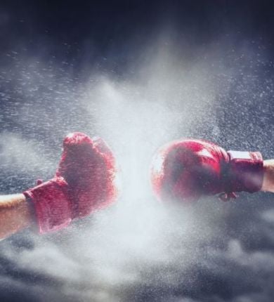 photo of 2 people punching in red boxing gloves