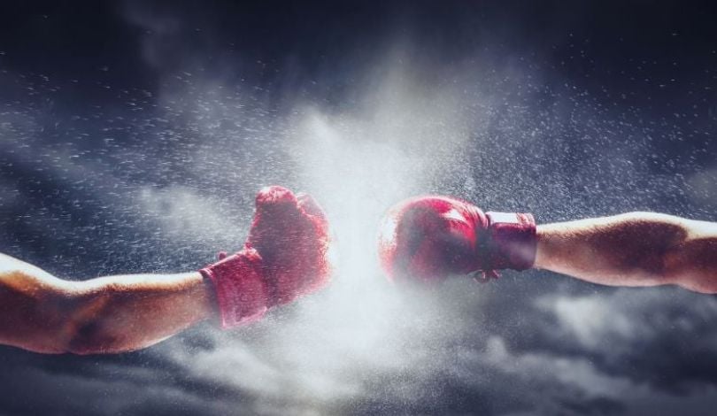 photo of 2 people punching in red boxing gloves