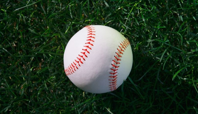 image a baseball on a grass field
