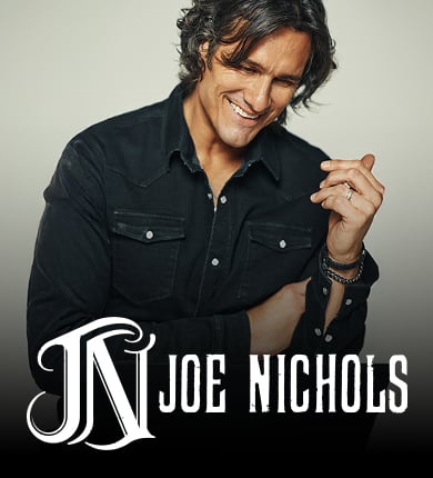 Man in a black button up shirt with swoopy black hair named Joe Nichols