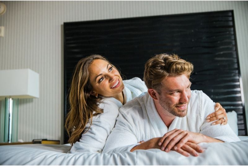 Hotel promo of couple on bed