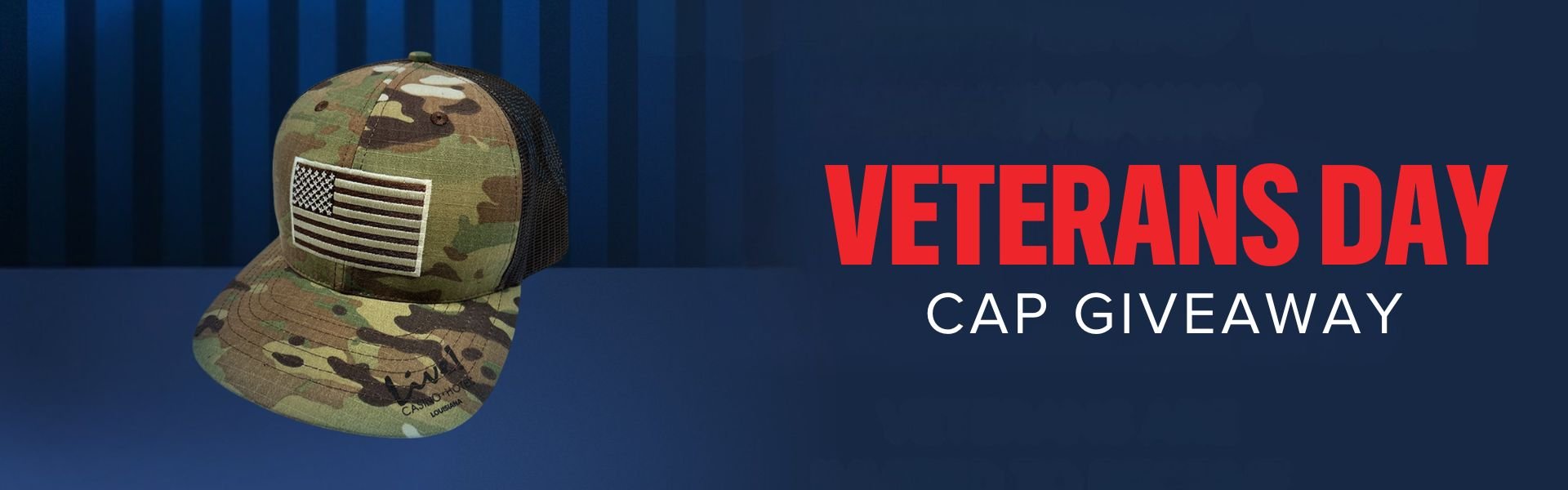 Veterans Day Cap Giveaway. Army green/camo baseball cap with an American flag on it in front of a dark blue background.