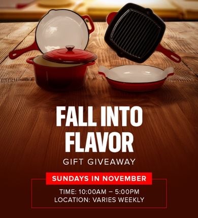 Fall into Flavor Gift Giveaway. Four types of pots/pans/bakeware that are all a dark red color sitting on a wooden table.