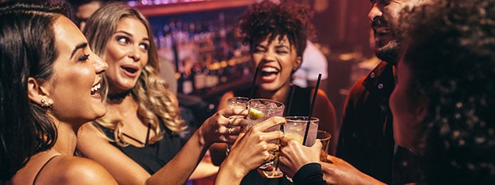 four women drinking cocktails