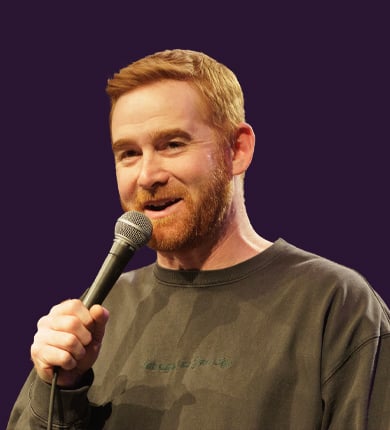 comedian Andrew Santino talking into a microphone