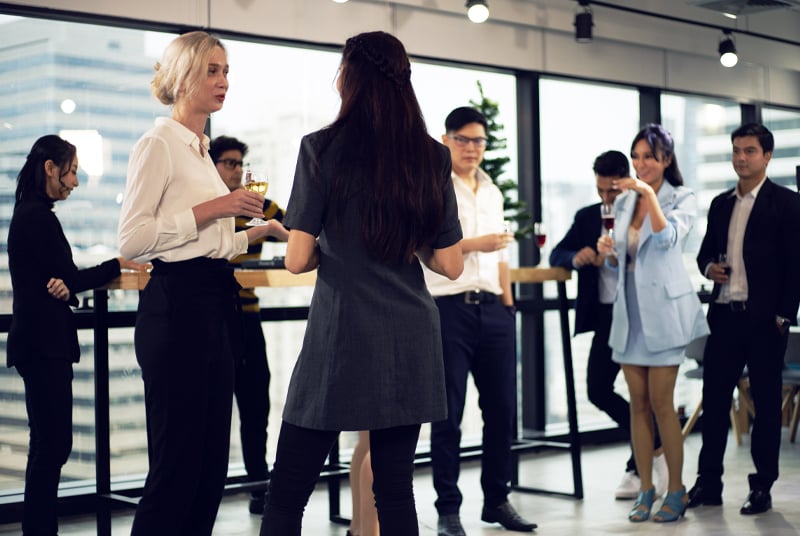 People in business casual ware drinking cocktails