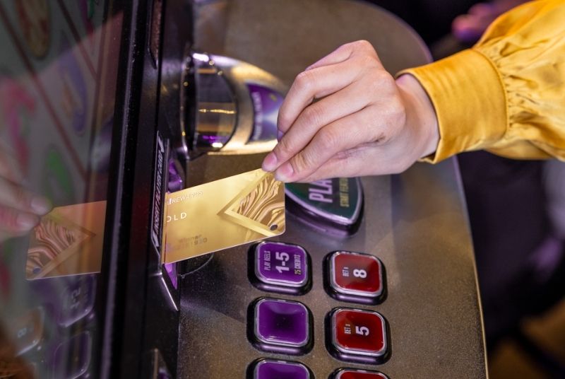 Closeup shot of Live! Rewards Gold card being used at a slot machine.