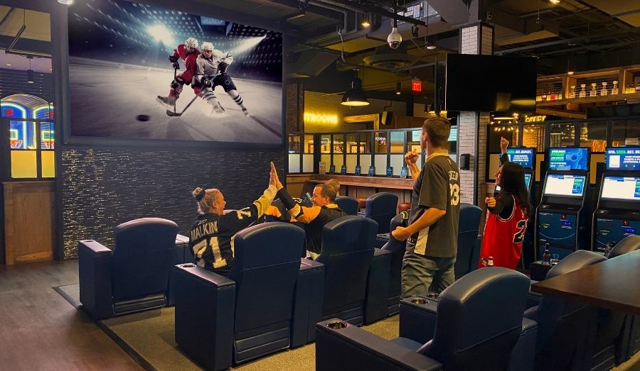 Fans Cheering on a Hockey Game on TV in the FanDuel Lounge