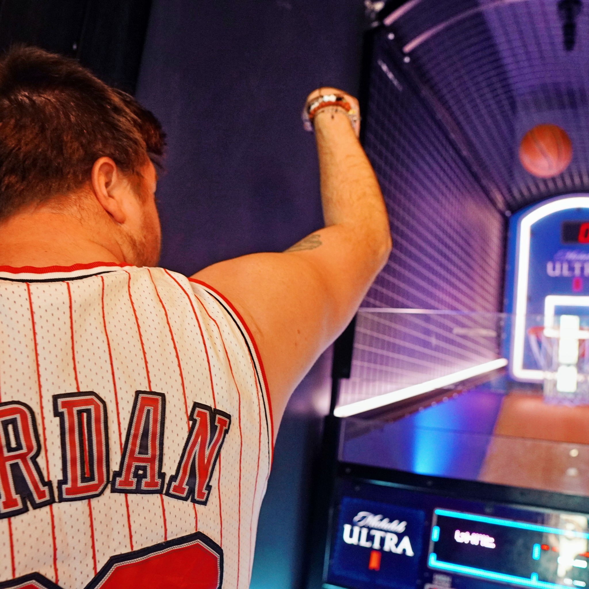 Guest playing pop-a-shot at sports & social