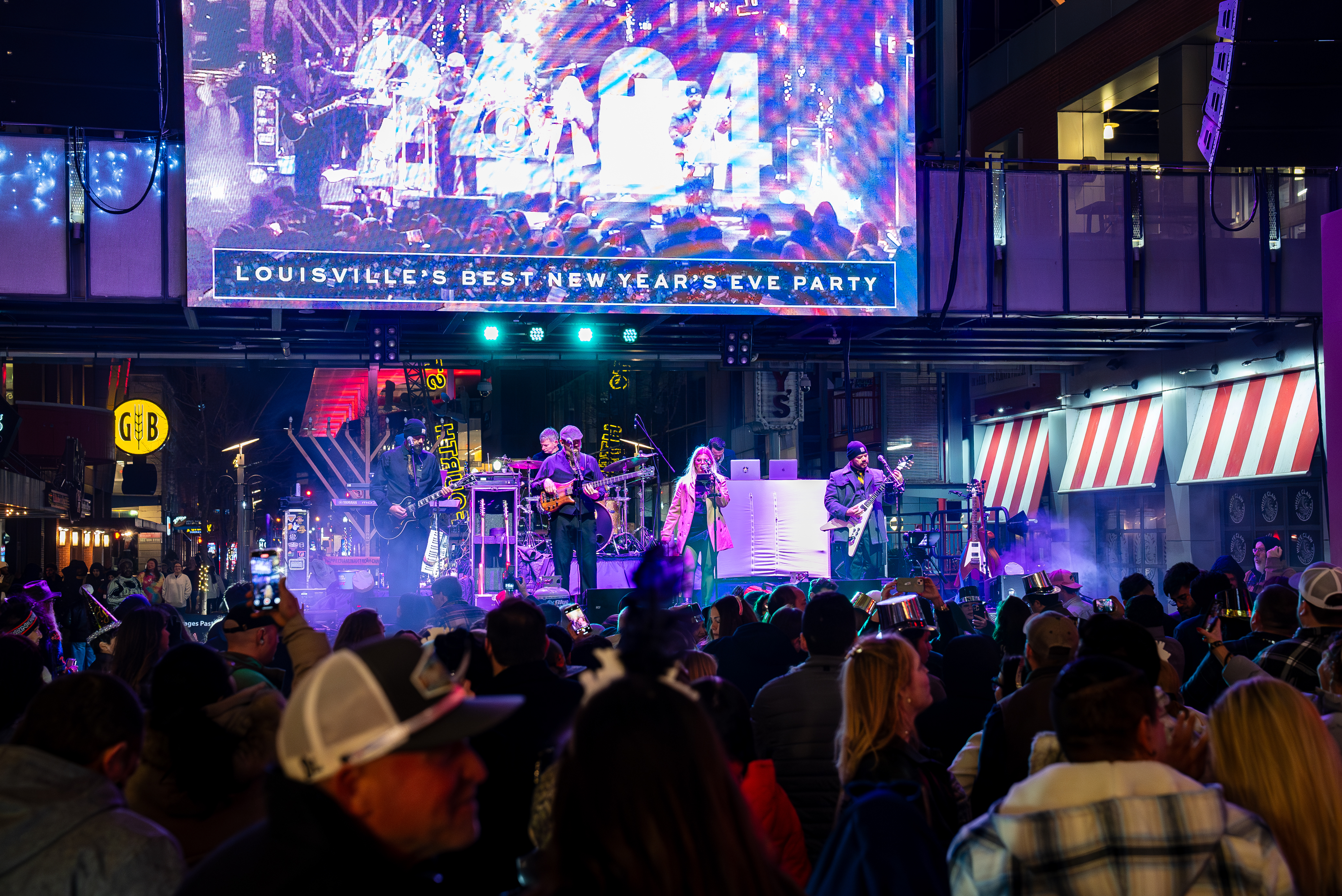 A band playing music on stage at NYE Live!