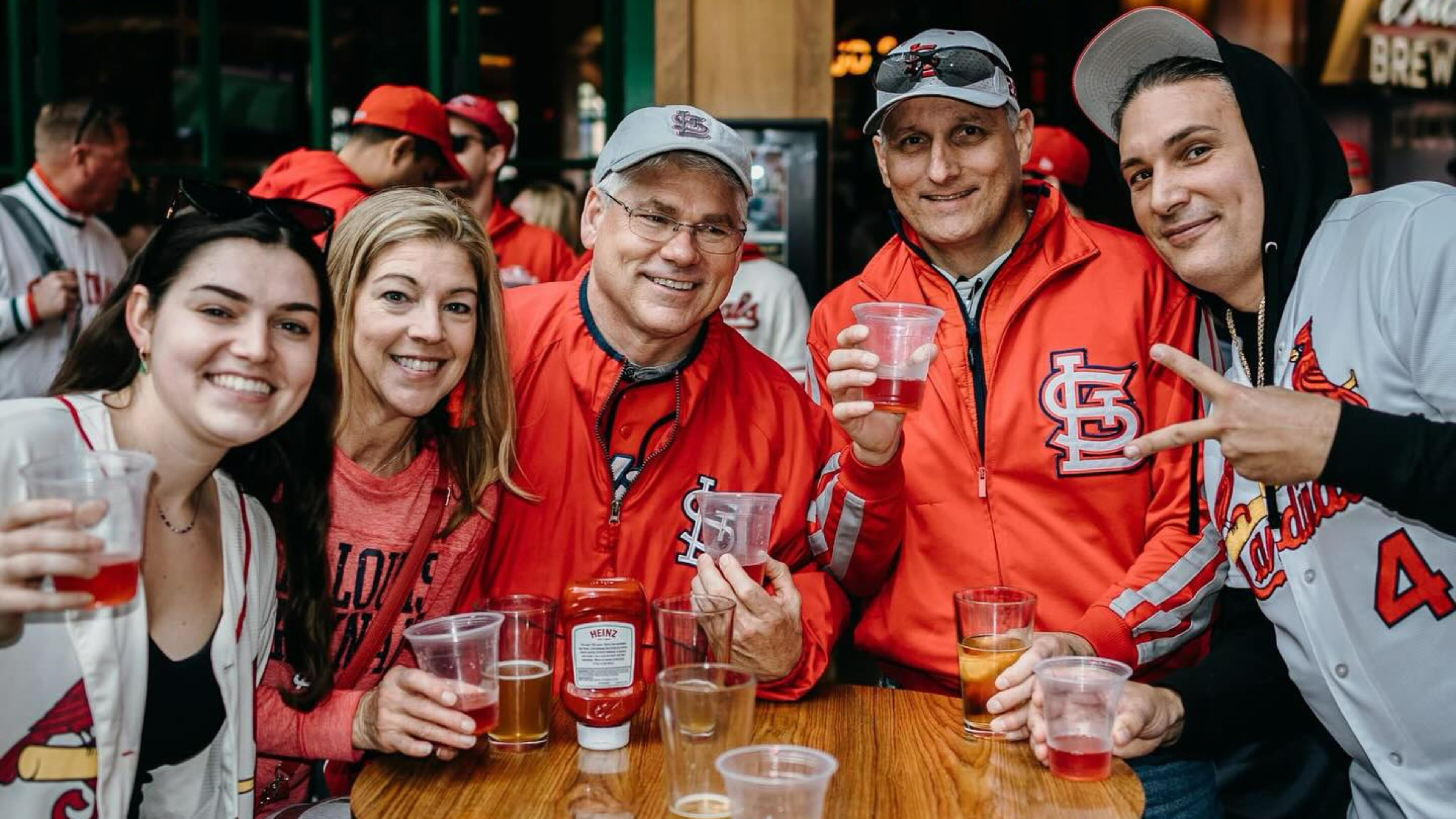 Family celebrating Cardinals game at Ballpark Village