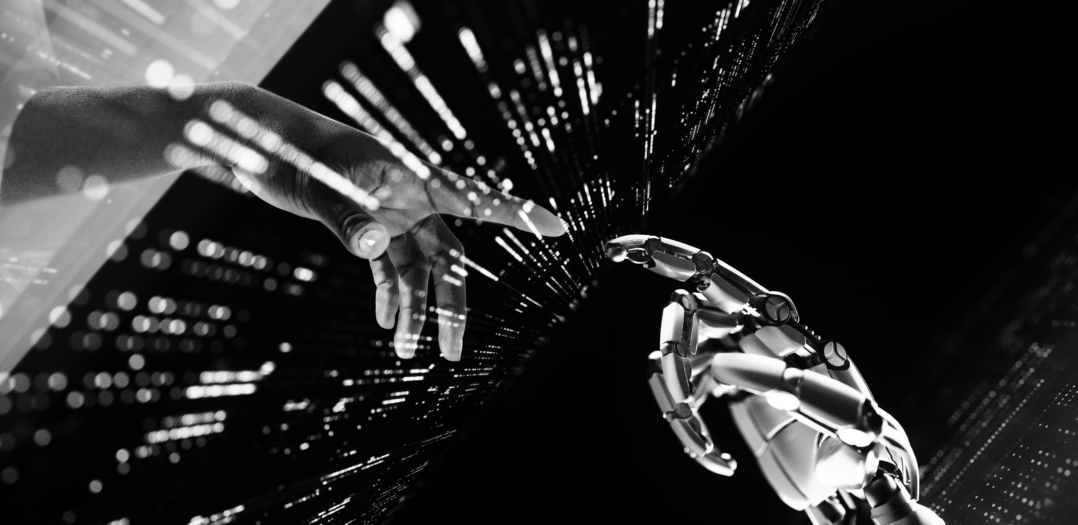 Human and robot hands reaching out to touch