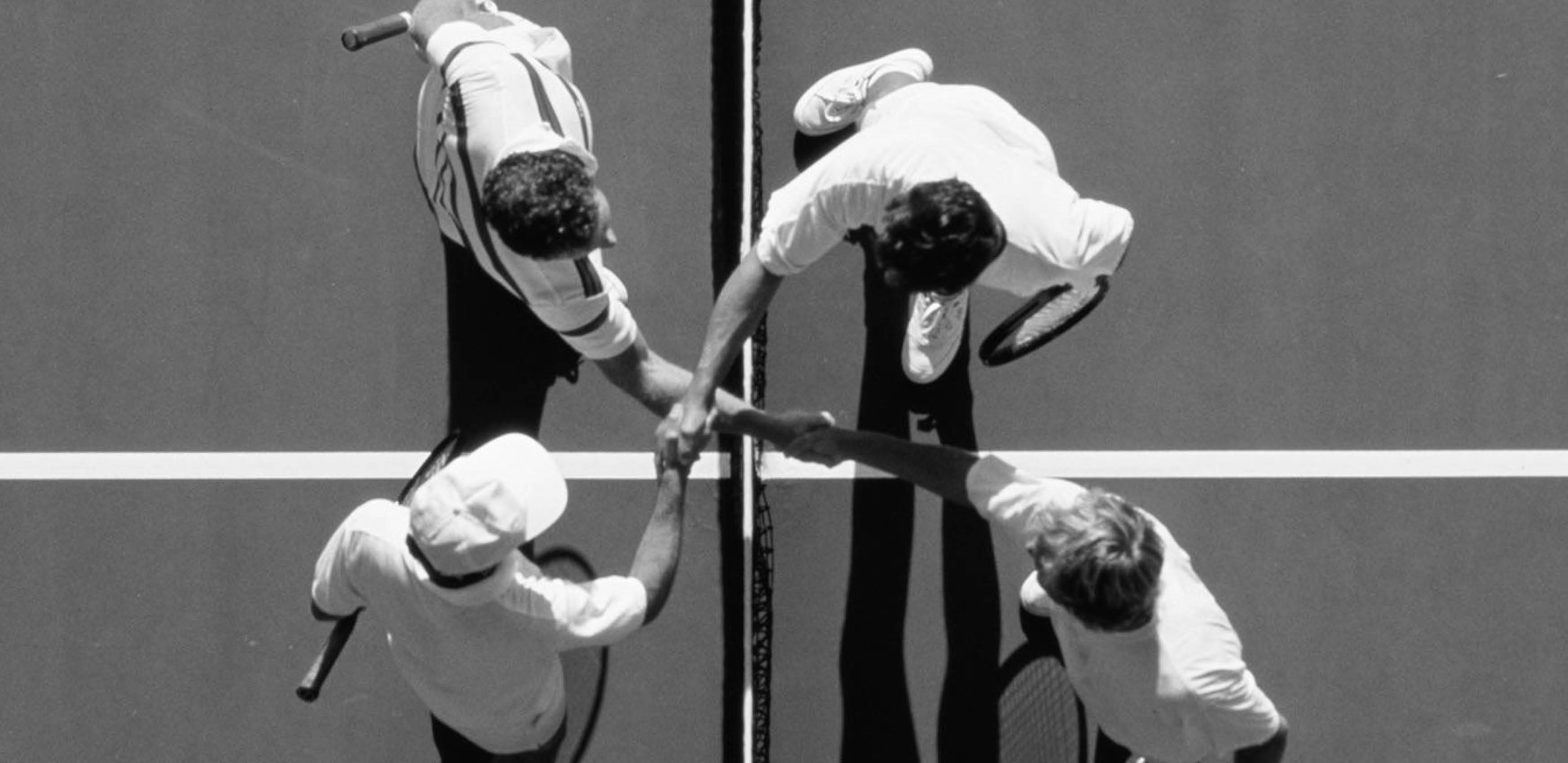 Aerial view of men shaking hands across tennis net