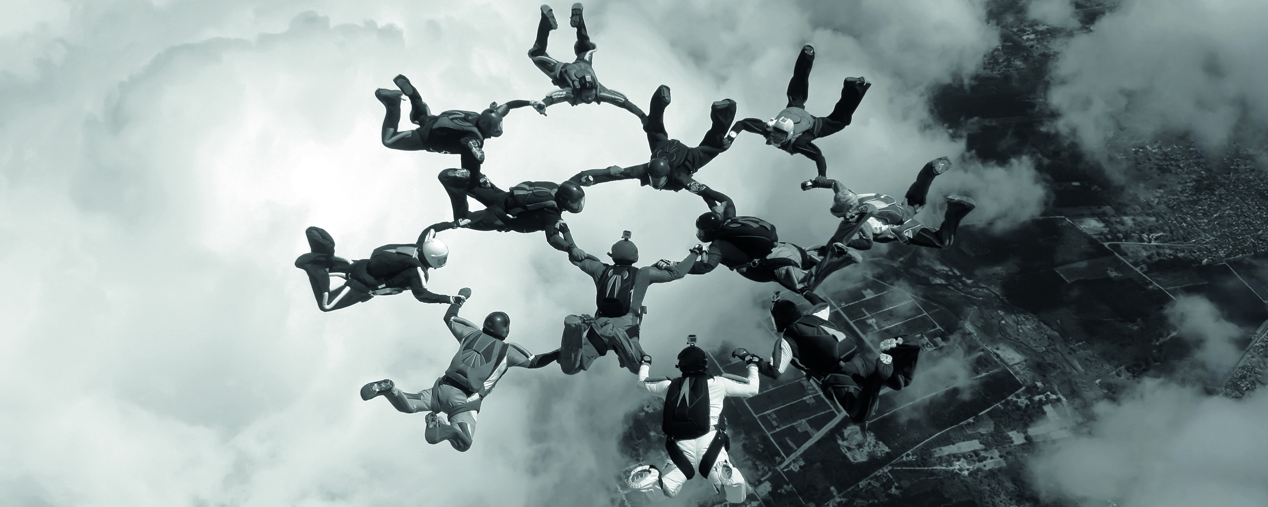A group of skydivers performing aerial acrobatics